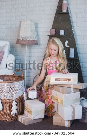 The girl and a lot of boxes with gifts, the joy, the preparation for the holiday, packaging, boxes, Christmas, New Year, lifestyle, holiday, vacation, waiting for santa