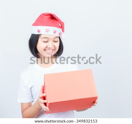 young attractive asian girl in Santa hat and red gift box