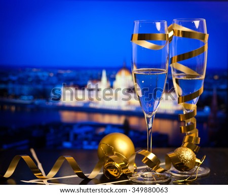 New Year in Budapest - Champagne glasses and Budapest parliament with fireworks in the background