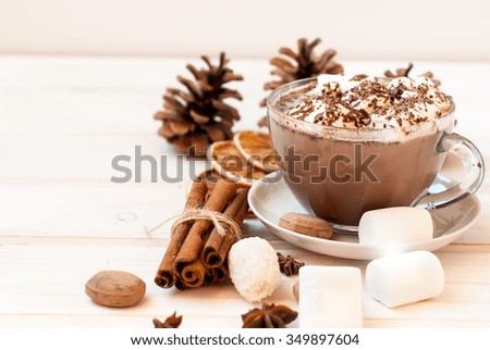 Cocoa drink with marshmallows on the wooden table cinnamon sticks, spices, selective focus, toned photo