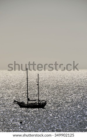 Backlight Picture of a Silhouette Boat in the Ocean