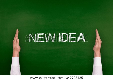 Hands Showing NEW IDEA on Blackboard