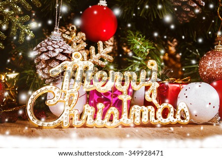 Merry Christmas on snow and wooden background