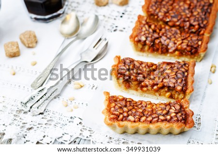 honey pine nuts tart on a white wood background. toning. selective Focus