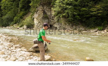 Fishing in the beautiful mountain river. Trout fishing in the mountains. Exciting fishing and beautiful scenery. Photos for natural and fishing magazines, posters and websites.
