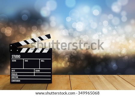 Slate film, Film clapper or Movie director slate on wood table. Blur and bokeh on background. for production of film Concept 


