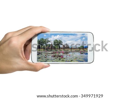 Holding a smart phone ,Take a picture Sukhothai-Historypark. Sukhothai. Thailand.