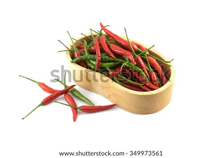 Red and green chillis in the box on white background