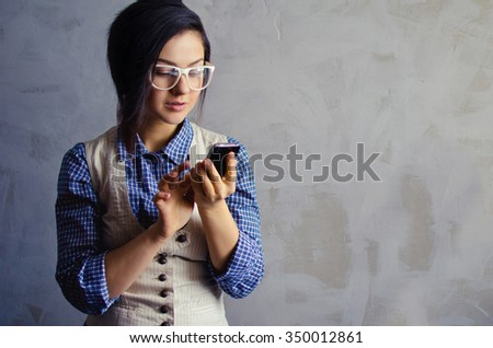 close up isolated portrait of a young woman working with cellphone