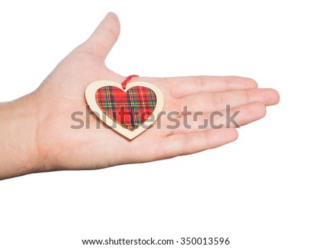 Wooden heart in his hand isolated on white background.