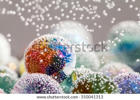 Abstract underwater composition with colorful glass balls, bubbles and light