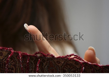 Caucasian women finger in number sign