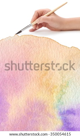 hand with paint brush and color painted background