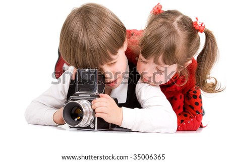 Adorable children taking pictures with photo camera