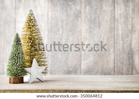 Gold and green christmas tree on a wooden background.