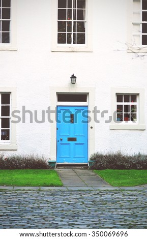Traditional building with front door in England - toned picture