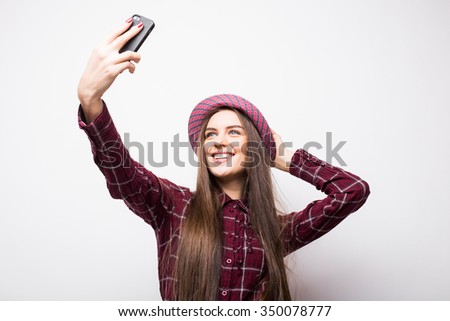 Selfie time. Joyful young women making selfie by her smart phone