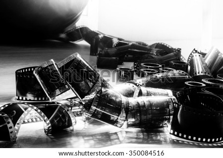 Vintage film spools and film footage on a white wooden background. Space for text Royalty-Free Stock Photo #350084516