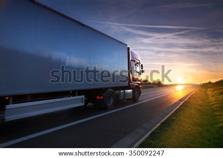 Truck transportation on the road at sunset Royalty-Free Stock Photo #350092247