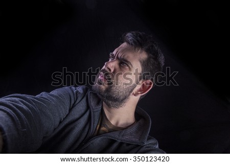 angry man on black background

