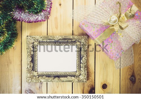 Christmas decoration with picture frame on wooden background. Winter holidays