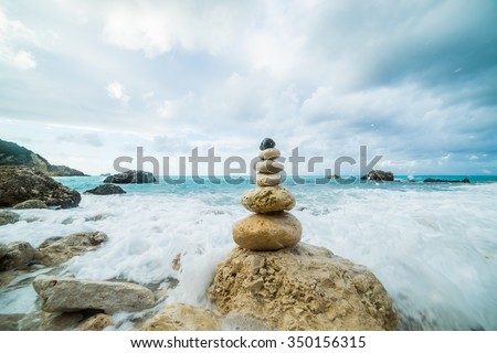 Sea dramatic landscape, harmony environment and zen stones tower silhouette.
