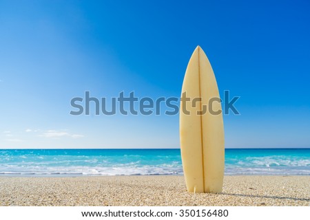 Surf board in the sand at the beach Royalty-Free Stock Photo #350156480