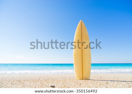 Surf board in the sand at the beach Royalty-Free Stock Photo #350156492