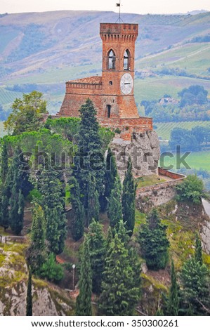 Brisighella clock tower and cypress trees in Italy