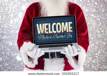 Santa Claus presents a laptop against vintage open sign