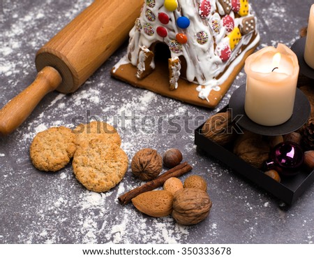 christmas decoration with lebkuchen- house, cinnamon, candles and cookies