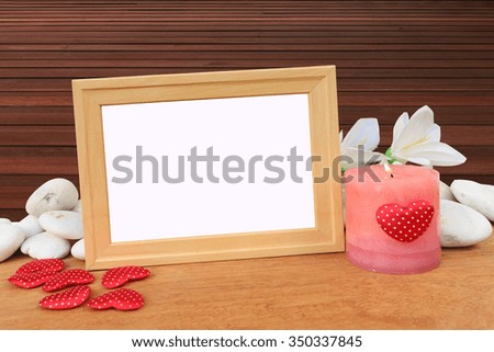 picture frame and candle with wooden floor background