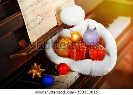 Piano keys decorated with Santa's hat, close up