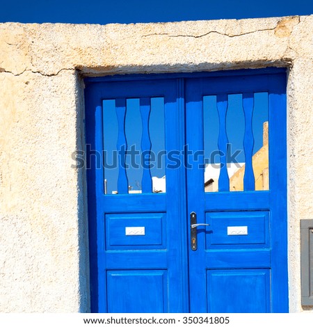 blue door      in antique village santorini greece europe and white wall