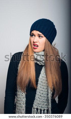 bright girl irritated winter concept studio photo isolated on a gray background
