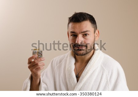  close bright picture of handsome man  bathrobe with gift box
