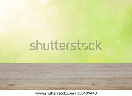 Wood table and nature green bokeh lights background - used for display your products