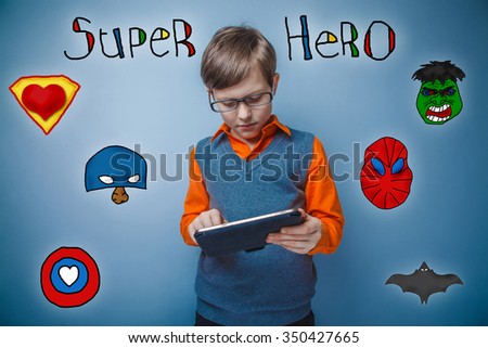 Teen boy retro style works enthusiastically on the tablet superhero super power of the photo studio Icons hero