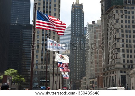 United States flag and National flag of Chicago seen in front of the 333 North Michigan skyscraper, which is an Art Deco in Chicago. It is famous for it's upper level setbacks.