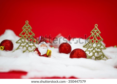 Santa Claus figurine with gift on red background