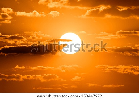 Bright big sun on the sky with yellow orange gradient colors in a calmly morning.