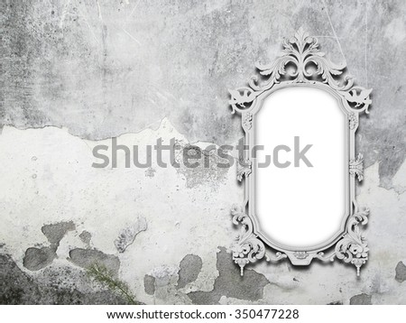 One silver baroque picture frame on grey moulded concrete wall background