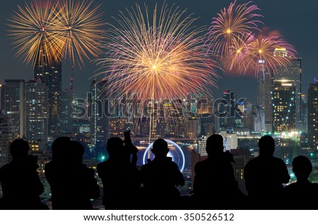 The silhouette of reporter photograph the Fantastic festive new years colorful fireworks with bangkok cityscape at night scene, holiday concept