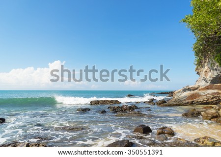 Blue sky,beach ,cloud,sea,wave and beautiful stone on nice day:select focus with shallow depth of field:ideal use for background.