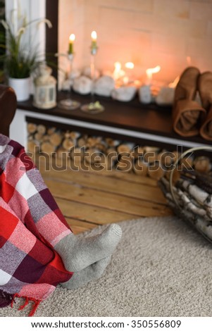 Santa Claus Warming near Fireplace at Home