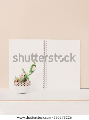 Vintage valentine card with succulents in decorated pot and notebook. Still life