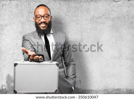 business black man holding a suitcase