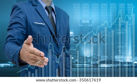 business man and visual graph on screen with night city background