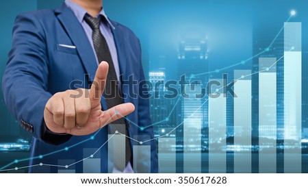 business man touch visual graph on screen with night city background