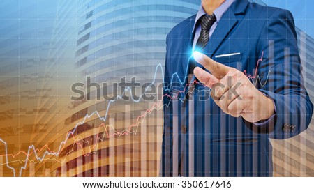 business man touch visual graph on screen with modern building background